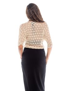 The Knitted Bolero Motiv features an iridescent mother of pearl shell button closure. The body of this bolero is triangle shape with mid length sleeves and a pointed back hem. This crochet piece envelopes whatever you choose to wear underneath it and the detail on it is easily dressed up or down. It lays close to the body and sits at or above the waistline. It's breathable with wonderful airflow and is a perfect item to travel with as it can be worn in many situations. It is made of a super soft Elegant Fitted V-neck Crochet Top, Elegant Fitted Cardigan With Short Sleeves, Elegant Fitted Crochet Top With V-neck, Elegant 3/4 Sleeve Cardigan For Party, Elegant Crochet Top With Open Knit V-neck, Elegant Open Knit Party Tops, Elegant V-neck Open Knit Crochet Top, Elegant Fitted Open Knit Top, Elegant Fitted Open Knit Cardigan