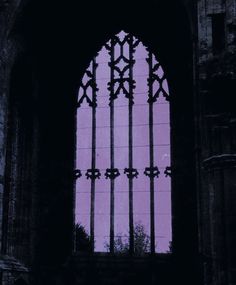 an image of a window that is in the dark with purple light coming through it