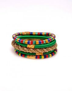 Named for the island, our "Nevis" grouping is anchored by a thick, bejeweled golden/bronze bangle. Flanking this chunky metal bangle are two deep green, skinny silk bangles. Providing very festive endcaps to this grouping are two more colorful striped bangles. www.hamptonbanglecompany.com #bracelets #fashion #jewelry #trend #style #accessory #sexy #bangles  #imaginehappy Bronze Bangle, Silk Bangles, Bracelets Fashion, Trend Style, Deep Green, Rope Bracelet, 404 Not Found