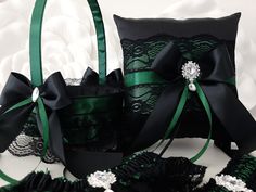 two black and green wedding garters, one with a satin ribbon around it