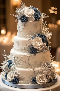 a three tiered wedding cake with blue and white flowers