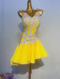 a yellow and white dress on a mannequin