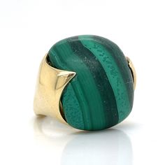 This vintage Mid-Century cocktail ring features a 34.50 carat cabochon cut malachite in 14 karat yellow gold. A statement ring with a timeless style. The green malachite features a gradient turquoise meets green color effect. The green-banded gemstone is set on a warm 14 karat yellow gold band with pointed prongs. A right hand ring that is a wearable work of art! Malachite Ring, Right Hand Ring, Malachite Rings, Green Malachite, Right Hand Rings, Hand Ring, Color Effect, Ring Gold, Gold Band