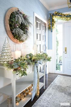 a decorated entryway with wreaths and candles