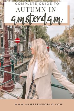 a woman standing in front of a canal with text overlay reading the complete guide to autumn in amsterdam