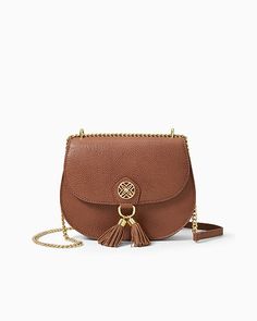 Crossbody bag with gold metal logo hardware, fringed tassels, and a gold metal chain strap. Measures 8 1/2"W x 7"H x 2"D with a 22" crossbody drop.  Shrunken Leather. Spot clean only. Imported. Complete your look with our elegant Sirena Leather Crossbody Bag. Luxury Gold Bags With Tassels, Elegant Gold Bag With Fringe, Chic Tassel Crossbody Shoulder Bag, Luxury Shoulder Bag With Fringe, Chic Crossbody Shoulder Bag With Tassels, Gold Tassel Bags For Formal Occasions, Gold Bags With Tassels For Formal Occasions, Elegant Crossbody Bag With Tassels, Luxury Travel Shoulder Bag With Tassels