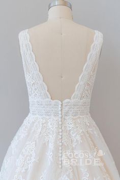 the back of a white dress on a mannequin headdress with lace detailing