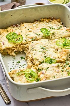 a casserole dish with green peppers and cheese on top, ready to be eaten