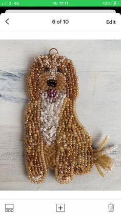 a beaded dog ornament is shown on the phone's display screen