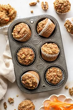 carrot muffins in a muffin tin with other muffins around them