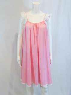 "Truly a pretty nightgown. By Lucie Ann and from Saks Fifth Avenue Satin trim along neckline with white floral lace trim Pink 100% nylon  Size: Small Measures laying flat: 19\" armpit to armpit, 35\" shoulder to hem Excellent condition" Spring Nightgown With Lace Trim For Bedtime, Sleeveless Summer Sleepwear With Contrast Lace, Summer Sleepwear With Contrast Lace, Summer Nightgown With Lace Patchwork, Feminine Lace Patchwork Nightgown For Summer, Feminine Nightgown With Lace Trim For Home, Feminine Lace Trim Nightgown For Home, Lace Nightgown With Lace Trim For Sleep, Lace Bodice Nightgown For Loungewear