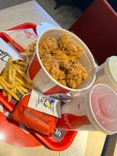 chicken nuggies and french fries are served on a tray at a fast food restaurant