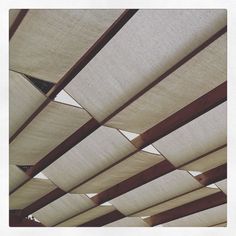 the underside of a wooden structure with white fabric covering it