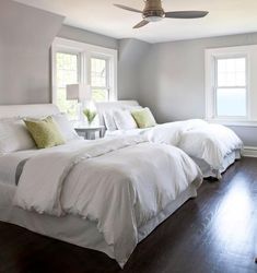 a bedroom with a large bed and white pillows