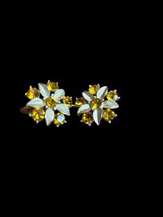 Vintage Sarah Coventry clip on earrings in flower pattern with topaz color gems. Great retro costume jewelry piece! Great for a gift~easy to match different outfits. It's a perfect gift for Mother's Day, birthday, etc.  Perfect for many Occasions~ daily, Wedding, Jackie-O, Maisel or any 50s-60s era themed outfits, so many options! Please see pictures for further description.  I do combine shipping for cheaper cost to you whenever possible. I have lots of Vintage items listed on Etsy right now. I 1950s Jewelry, Retro Costume, Topaz Color, Sarah Coventry, Colored Gems, Themed Outfits, Coventry, Flower Jewellery, Easy Gifts