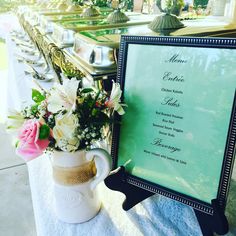 a table with a menu and flowers on it