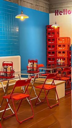 there are many chairs and tables in the room that is blue with red letters on it