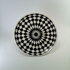 a black and white plate with a circular design