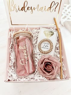 the bridesmaid gift set includes a pink rose and gold straw