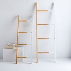 a ladder leaning up against a white wall