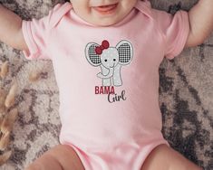 Important holiday update: Christmas delivery on orders placed after Dec. 8th are not guaranteed to arrive before Christmas. If placing an order after this date, refunds will not be offered due to arrival post Christmas holiday. Adorable Bama girl elephant design. A must have for Alabama alumni and fans.   6M 12M 18M 24M Width, in 8.66 10.00 11.02 12.01 Length, in 12.48 13.50 14.49 15.51 Sleeve length, in 2.76 2.99 3.23 3.50 Baby clothing needs to be both durable and soft. With the infant fine jersey bodysuit, youths get just that. The fabric is 100% cotton for solid colors. For heather colors, polyester is included. There are seams along the sides of this product. All bindings are made with ribbed knitting for improved durability. There are plastic snaps at the cross closure for easy chang Pink Cotton Bodysuit With Name Print, Pink Short Sleeve Bodysuit With Letter Print, Pink Short Sleeve Onesie For Gender Reveal, Pink Cotton Onesie With Custom Print, Alabama Gifts, Alabama Baby, Bama Girl, At The Cross, Elephant Design