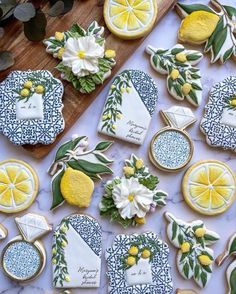 decorated cookies with lemons and flowers on a table