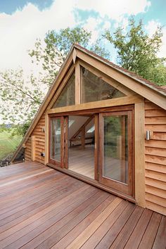 a wooden deck with sliding glass doors on it