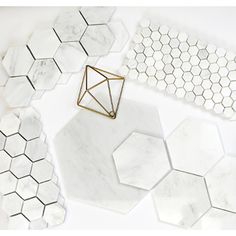 white marble hexagonal tiles with gold accents and geometric shapes on the table top