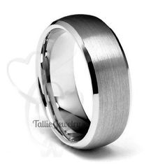 a stainless steel ring with a heart in the center and polished finish, on a white background