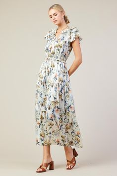 Between the pretty floral print and all those ruffles, this tiered maxi dress exudes romance. It's tied at the neckline, layered beautifully at the sleeves, and comfortably cinches in at the waist. •Split neckline with self-tie •Ruffle trim •Layered short sleeves •Elasticized waist •Tiered Item Number: 96222 100% POLYESTER Dress Length: 54 1/2" Feminine Flowy Floral Print Tiered Dress, Flowy Feminine Tiered Dress With Floral Print, Feminine Flowy Tiered Dress With Floral Print, Feminine Floral Maxi Dress With Ruffle Hem, Elegant Tiered Floral Dress, Floral Ruffled Tiered Skirt Dress, Flowy Tiered Floral Dress, Tiered Floral Dress For Vacation, Tiered Floral Dress With Ruffles For Brunch