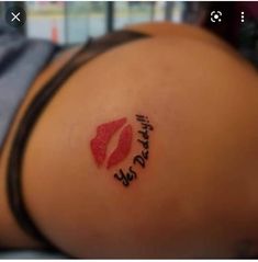 a woman's stomach with the word love written on it and a red lip