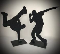 two black silhouettes of people doing tricks on skateboards