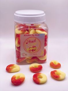 a jar filled with sliced peaches on top of a white table