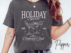 Holiday Cocktail Shirt, Christmas Shirt, Comfort Colors® Shirt, Holiday Gift T-Shirt, Xmas Gift, Holiday Party, Christmas Cocktail Club Trendy Holiday Christmas shirt from the comfort color collection. Available in sizes S-3XL. [T-SHIRT DETAILS] ✨Unisex Comfort Colors C1717 ✨Relaxed Fit ✨Sewn-in twill label ✨100% ring-spun cotton ✨DTG printing on to garments with ink jet technology ✨Ship from USA [CARE INSTRUCTIONS] ✨Machine wash: COLD ✨Tumble dry: LOW heat ✨Iron, steam or dry: LOW heat 🚫Do not Holiday Party T-shirt With Crew Neck, Christmas Party T-shirt With Graphic Print, Christmas Cocktail, Making Spirits Bright, Cocktail Club, Holiday Cocktail, Christmas Cocktails, Comfort Colors Shirt, Holiday Cocktails