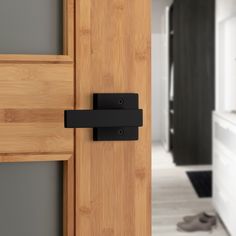 an open door with black handles in a kitchen