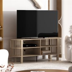 a flat screen tv sitting on top of a wooden entertainment center in a living room