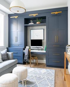 a living room filled with furniture and a flat screen tv on top of a desk