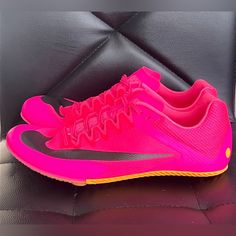 a pair of pink and black nike shoes