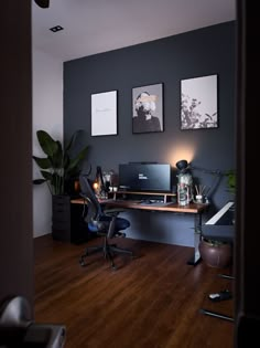 a home office with two framed pictures on the wall