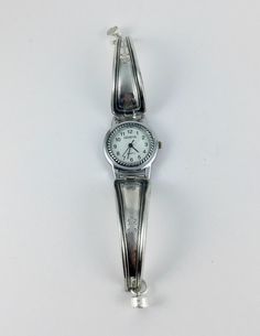 a silver wrist watch on a white background