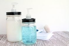 two mason jars with soap and toothbrushes in them