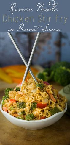 a white bowl filled with noodles and vegetables