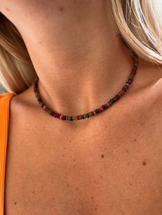 Experience the mystical energy of the cosmos with the Mixed Tourmaline Rondelle Beaded Crystal Choker. This boho-chic necklace features a mix of round Tourmaline beads in shades of pink, green, blue, and clear, accented by a sterling silver chain with lobster clasp. 3mm round Tourmaline rondelle beads Pink, green, blue, and clear Tourmaline 16-18 inches adjustable length Sterling silver chain and clasp. Harness the healing powers of Tourmaline with this crystal healing necklace. Tourmaline energ Festival Natural Stone Beaded Choker Necklace, Adjustable Bohemian Choker With Spacer Beads, Bohemian Beaded Choker Necklace With Spacer Beads, Bohemian Style Beaded Choker With Spacer Beads, Bohemian Beaded Choker, Festival Gemstone Beads Choker Necklace, Bohemian Crystal Necklace With Spacer Beads, Bohemian Crystal Gemstone Beads Choker Necklace, Bohemian Gemstone Bead Choker Necklace