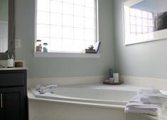 a white bath tub sitting next to a window