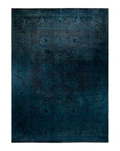 a blue rug with an intricate design on the top and bottom, is shown in full view