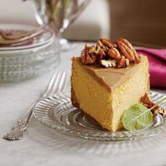 a piece of cheesecake on a plate with pecans in the middle and walnuts on top