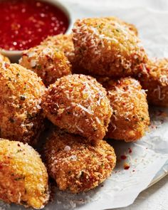 some fried food on a white plate with dipping sauce