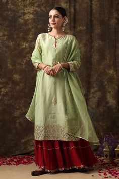 Light green kurta with embroidered floral motifs. Comes with sharara and dupatta.
Component: 3
Embroidery
Neckine: Notched round
Sleeve Length: Three fourth
Fabric: Kurta: Chanderi; Dupatta: Kota doria; Pant: Crushed cotton
Color: Green
Side slits on kurta
Front potli button placket on kurta
Zari trim detail on pant
Checkered detail on dupatta with zari trim detail on border
Embroidered floral motifs on dupatta - Aza Fashions Red Sharara, Cotton Sharara, Potli Button, Chanderi Dupatta, Green Side, Designer Saree Blouse Patterns, Sharara Set, Embroidered Neckline, Designer Dresses Indian