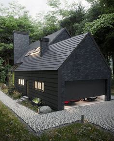 a black house in the middle of a wooded area with two garages on each side