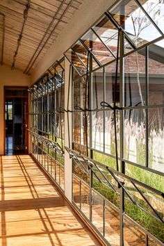 the inside of a building with lots of windows and wood flooring on both sides